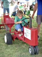 DRE Ashley Schmit, 8, of Coleridge concentrates hard as she competes in the kiddie pedal pull on Sunday at the Cedar County Fair._4172