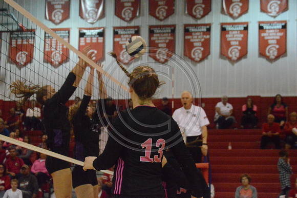Abby hochstein looks on at an attempted block by Battle Creek