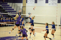 Belle Harms goes up for a block on Kaitlyn Heimes